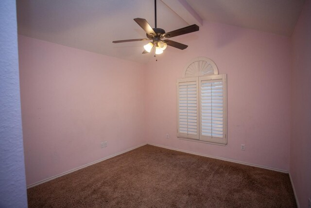 carpeted empty room featuring ceiling fan and vaulted ceiling with beams