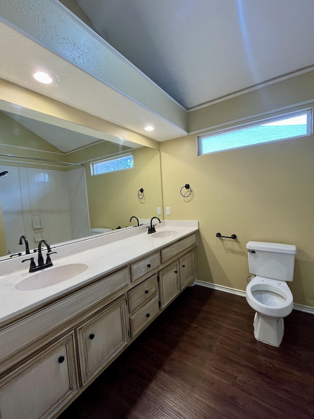 4910 102nd St, Lubbock, TX 79424 - bathroom featuring double vanity, wood finished floors, a shower, and recessed lighting