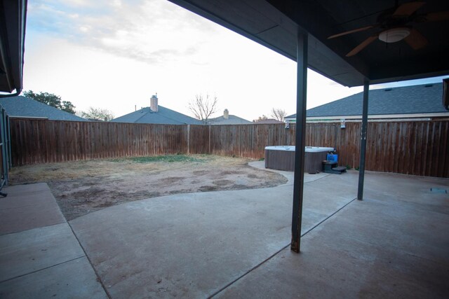 view of patio / terrace featuring a hot tub and ceiling fan