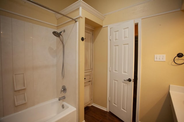 bathroom featuring vanity, hardwood / wood-style flooring, and washtub / shower combination