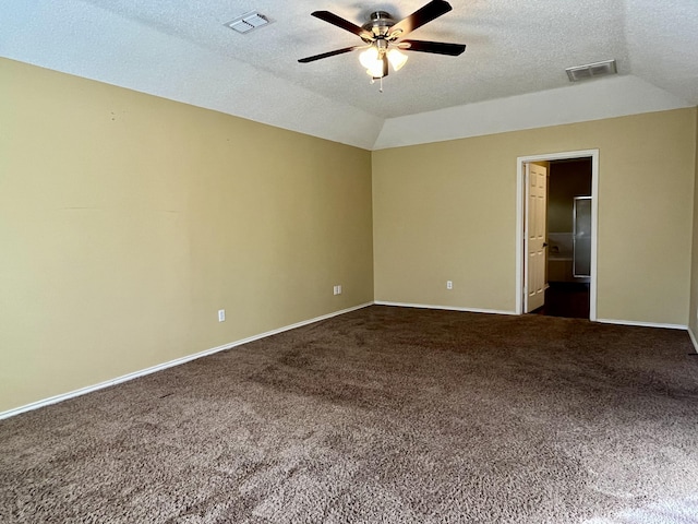 4910 102nd St, Lubbock, TX 79424 - empty room featuring a ceiling fan, vaulted ceiling, dark carpet, and a textured ceiling