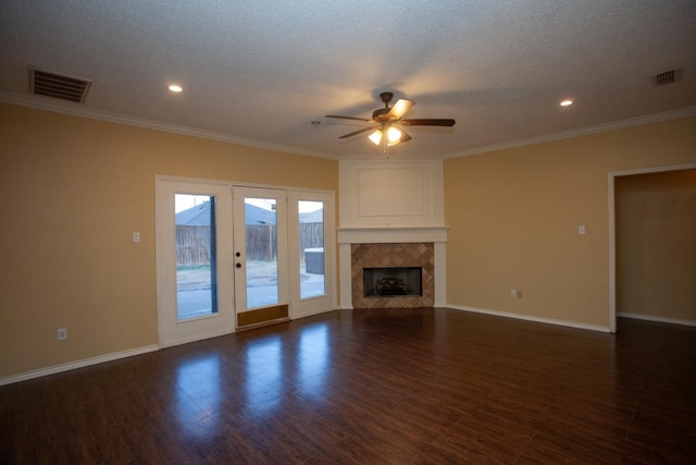 unfurnished living room with ceiling fan, dark hardwood / wood-style flooring, and a tiled fireplace