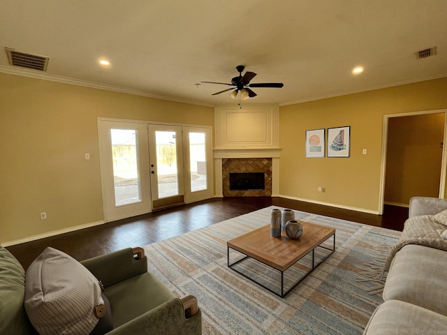 4910 102nd St, Lubbock, TX 79424 - living area with ceiling fan, crown molding, dark wood-type flooring, recessed lighting, and a tile fireplace