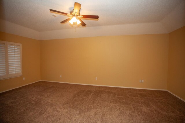 spare room featuring a tray ceiling, a textured ceiling, ceiling fan, and carpet flooring