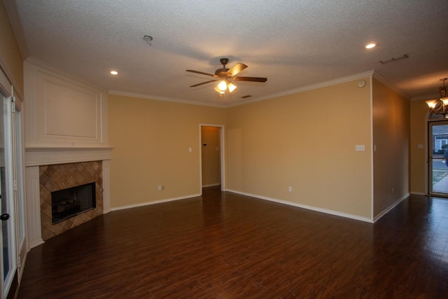 unfurnished living room featuring crown molding, a tile fireplace, a textured ceiling, dark hardwood / wood-style flooring, and ceiling fan with notable chandelier