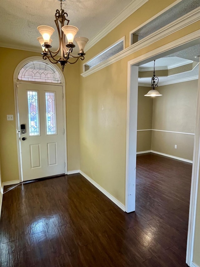 entryway featuring ornamental molding, a textured ceiling, and a notable chandelier