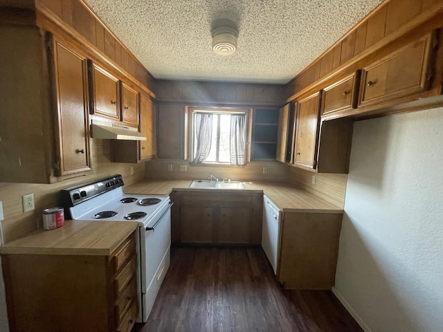 kitchen featuring dark hardwood / wood-style flooring, sink, a textured ceiling, and white appliances