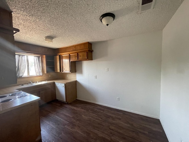 kitchen featuring dark wood-type flooring, stovetop, sink, a textured ceiling, and white dishwasher