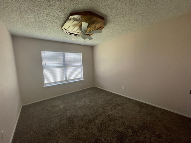 carpeted empty room featuring ceiling fan and a textured ceiling