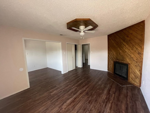 unfurnished living room with dark hardwood / wood-style floors, a textured ceiling, and ceiling fan