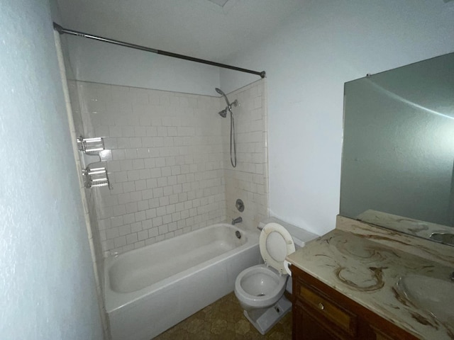 full bathroom with tiled shower / bath, vanity, and toilet