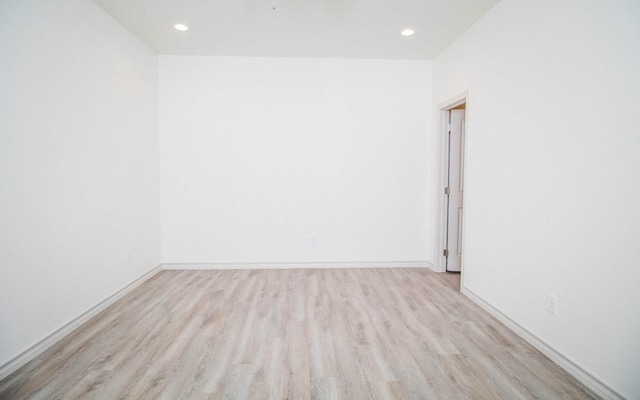 unfurnished room with light hardwood / wood-style flooring