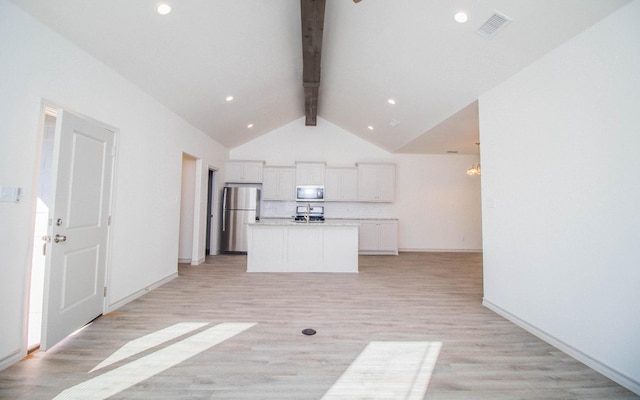 unfurnished living room with lofted ceiling with beams and light hardwood / wood-style floors