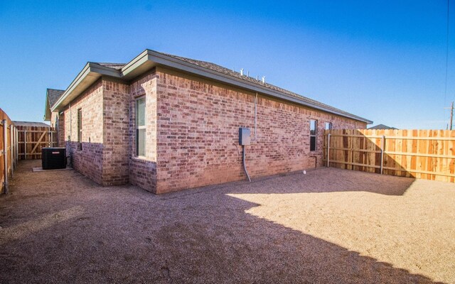 view of side of property featuring central air condition unit