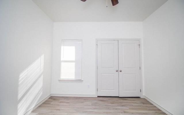 unfurnished bedroom featuring light hardwood / wood-style floors, ceiling fan, and a closet