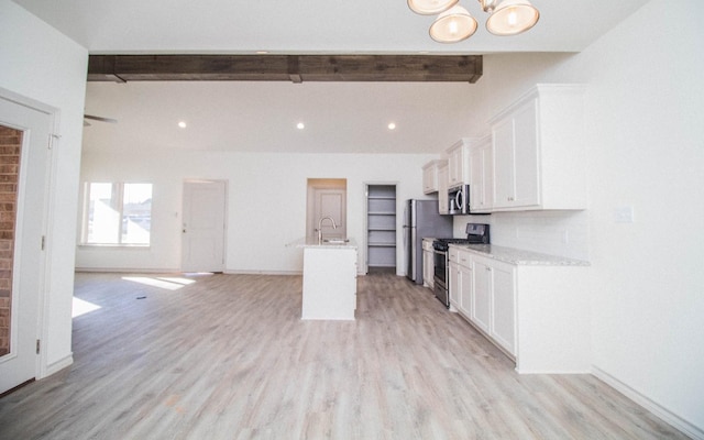 kitchen with sink, appliances with stainless steel finishes, white cabinetry, a kitchen island with sink, and beam ceiling