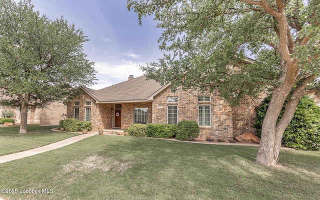 3914 101st St, Lubbock, TX 79423 - view of front facade featuring brick siding, a front yard, a chimney, and roof with shingles