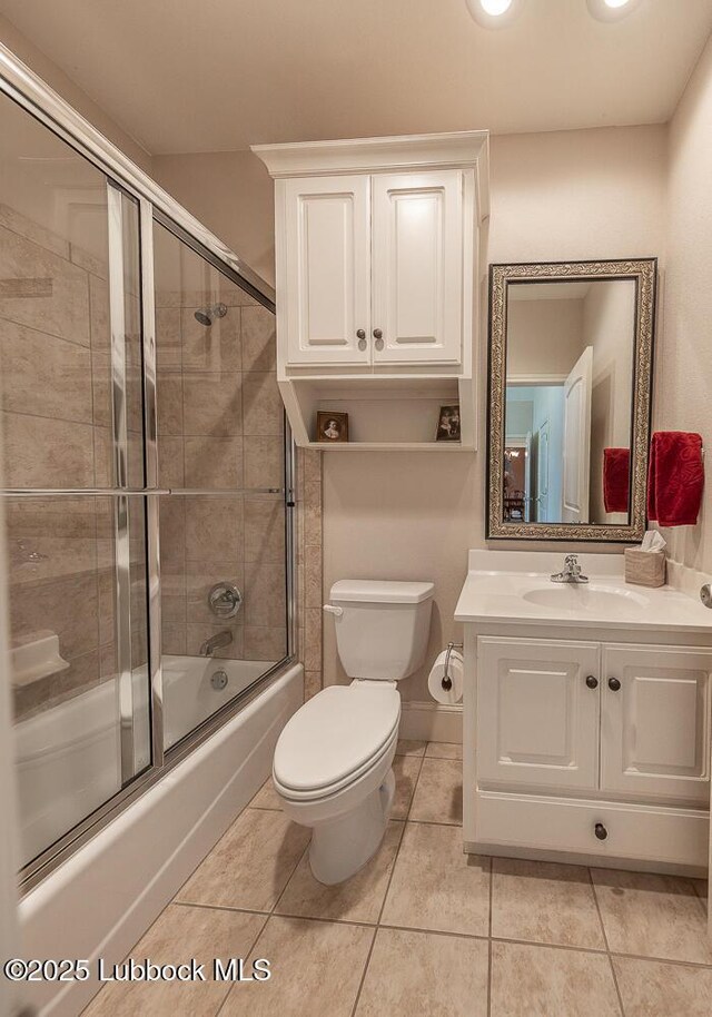 3914 101st St, Lubbock, TX 79423 - bathroom with bath / shower combo with glass door, vanity, and tile patterned flooring