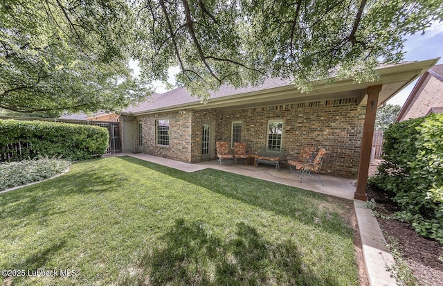 3914 101st St, Lubbock, TX 79423 - back of property with brick siding, a patio area, and a yard