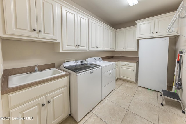 3914 101st St, Lubbock, TX 79423 - laundry area featuring cabinet space, separate washer and dryer, and light tile patterned flooring