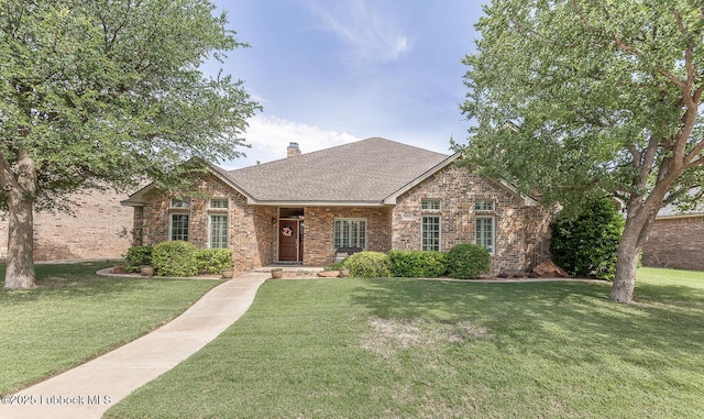 3914 101st St, Lubbock, TX 79423 - view of front of house featuring brick siding, a front yard, a chimney, and a shingled roof
