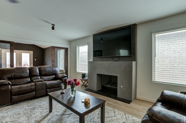 3711 128th St, Lubbock, TX 79423 - living area with light wood-type flooring, healthy amount of natural light, and a fireplace