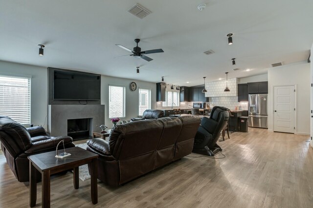3711 128th St, Lubbock, TX 79423 - living area featuring plenty of natural light, ceiling fan, light wood finished floors, a high end fireplace, and recessed lighting