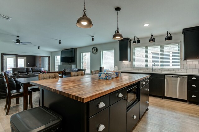 3711 128th St, Lubbock, TX 79423 - kitchen featuring dishwasher, wooden counters, black microwave, decorative backsplash, and dark cabinets