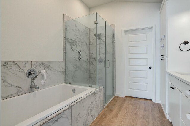 3711 128th St, Lubbock, TX 79423 - full bathroom with a marble finish shower, a bath, wood finished floors, and vanity
