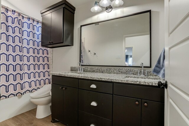 3711 128th St, Lubbock, TX 79423 - full bathroom with double vanity, wood finished floors, and shower / tub combo with curtain