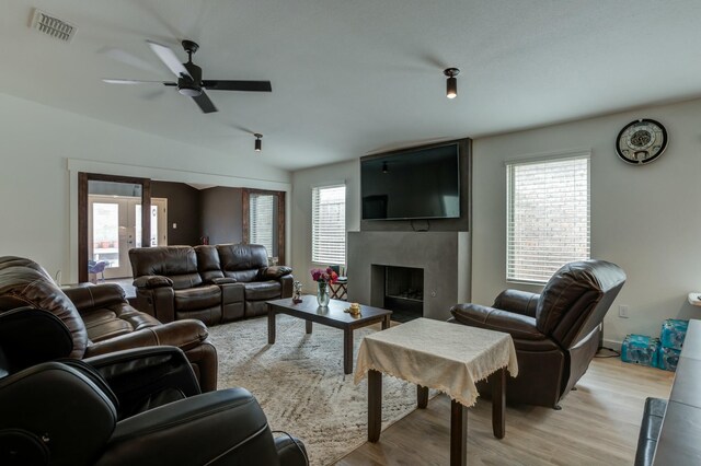 3711 128th St, Lubbock, TX 79423 - living area featuring healthy amount of natural light, light wood-type flooring, and a high end fireplace