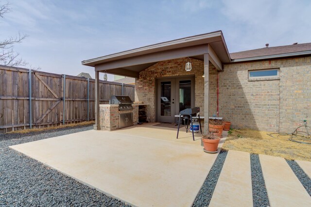 3711 128th St, Lubbock, TX 79423 - fenced backyard featuring exterior kitchen, a patio, and french doors