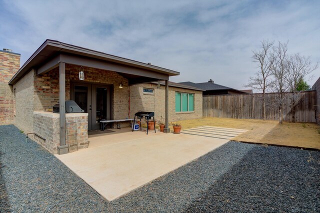 3711 128th St, Lubbock, TX 79423 - rear view of house featuring a patio area, a fenced backyard, and french doors