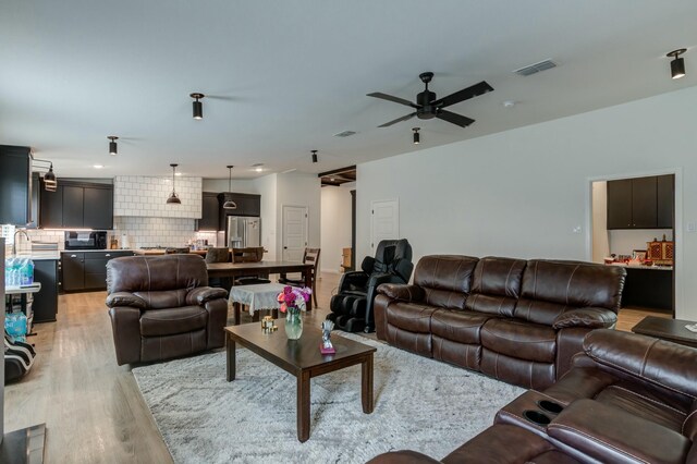 3711 128th St, Lubbock, TX 79423 - living room with light wood-type flooring and ceiling fan