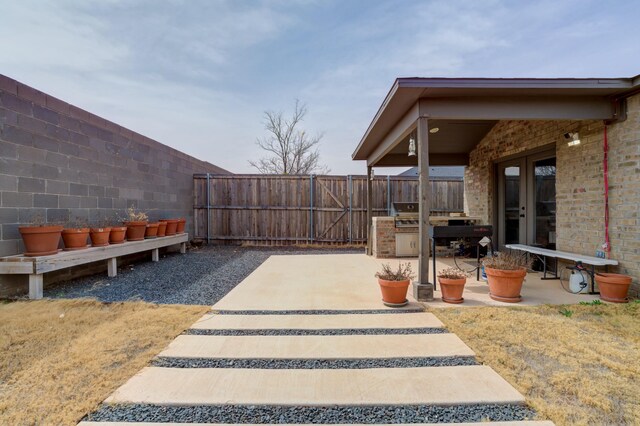3711 128th St, Lubbock, TX 79423 - fenced backyard with a patio area and french doors