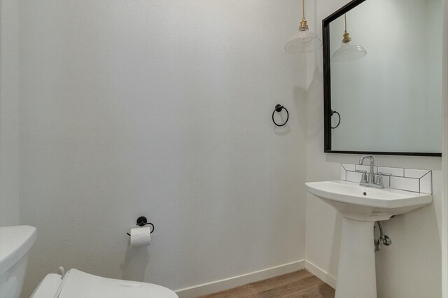 3711 128th St, Lubbock, TX 79423 - half bathroom featuring toilet and wood finished floors
