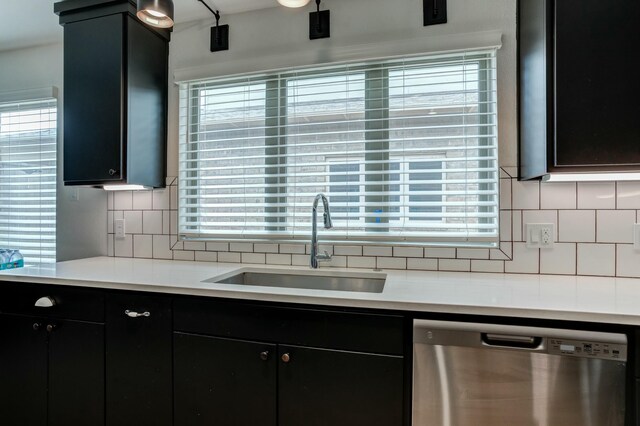 3711 128th St, Lubbock, TX 79423 - kitchen featuring stainless steel dishwasher, tasteful backsplash, light countertops, and dark cabinets