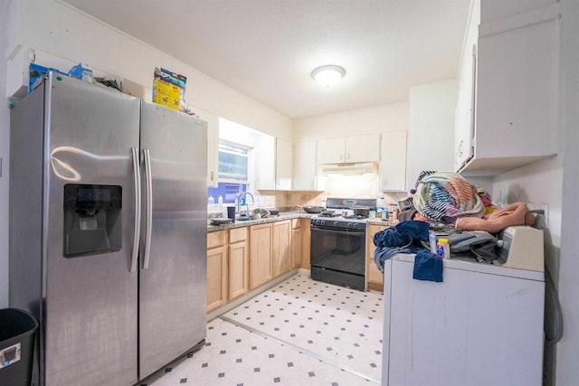 kitchen with stainless steel fridge, black gas stove, sink, and light brown cabinetry