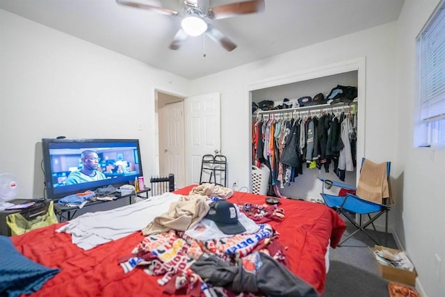 carpeted bedroom featuring ceiling fan and a closet