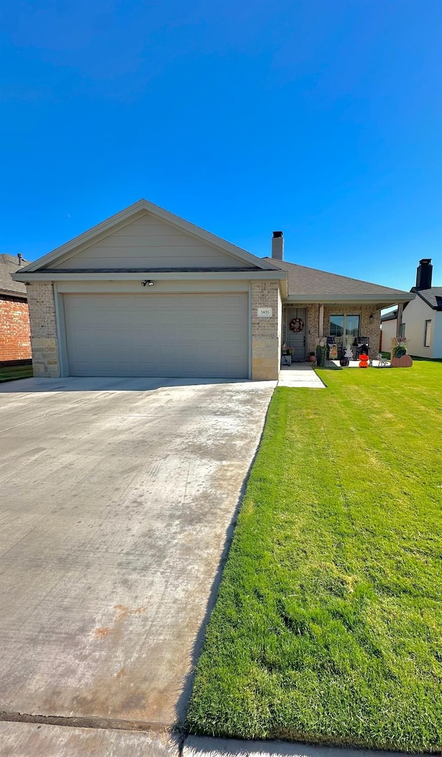 ranch-style house featuring a garage and a front yard