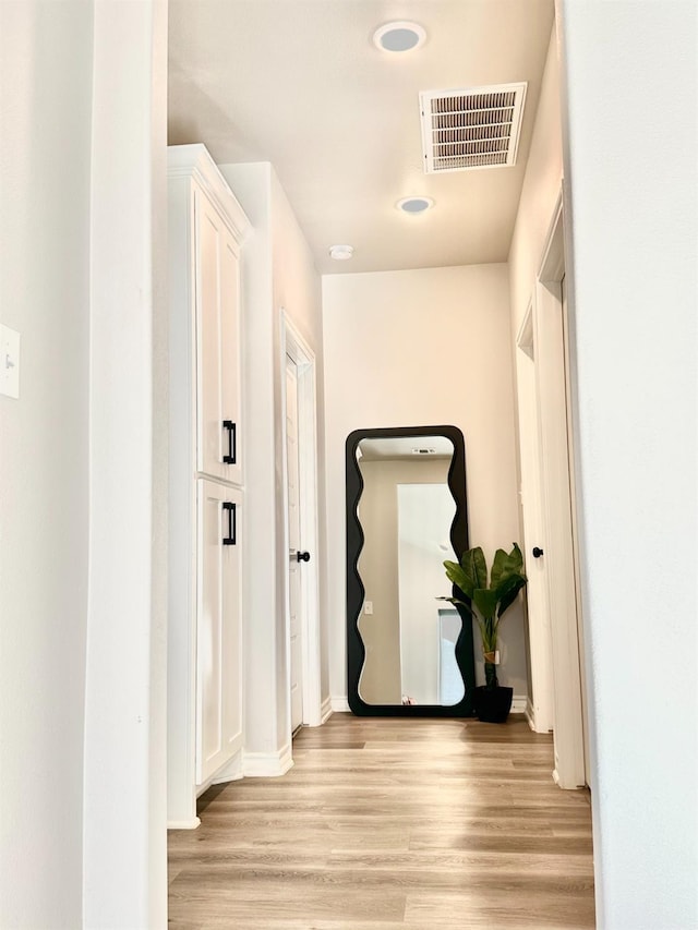 hall with light hardwood / wood-style flooring