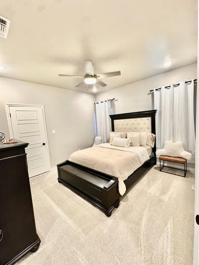 bedroom featuring ceiling fan and light carpet