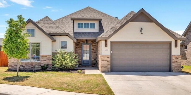 6803 52nd St, Lubbock, TX 79407 - view of front of property featuring brick siding, a shingled roof, driveway, and a garage