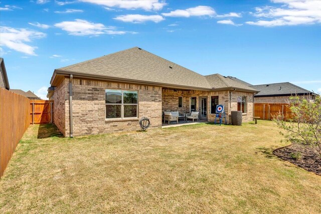 6803 52nd St, Lubbock, TX 79407 - back of house featuring a shingled roof, brick siding, and a patio area