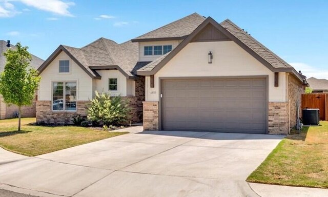 6803 52nd St, Lubbock, TX 79407 - view of front facade with brick siding, concrete driveway, a garage, and roof with shingles