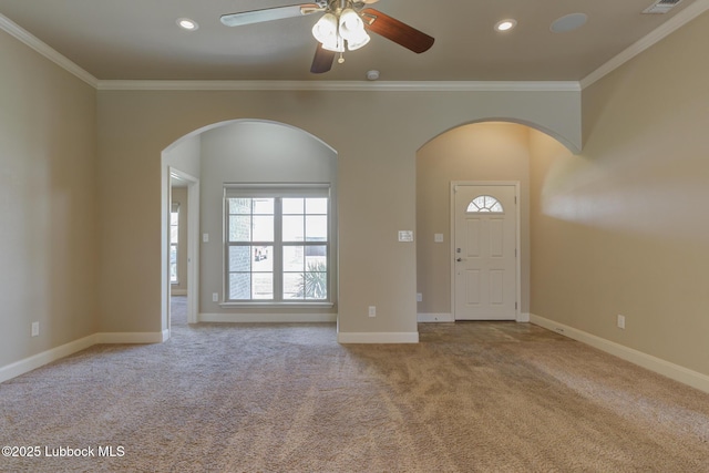 5207 Jarvis St, Lubbock, TX 79416 - entrance foyer featuring arched walkways, carpet, ornamental molding, a ceiling fan, and baseboards