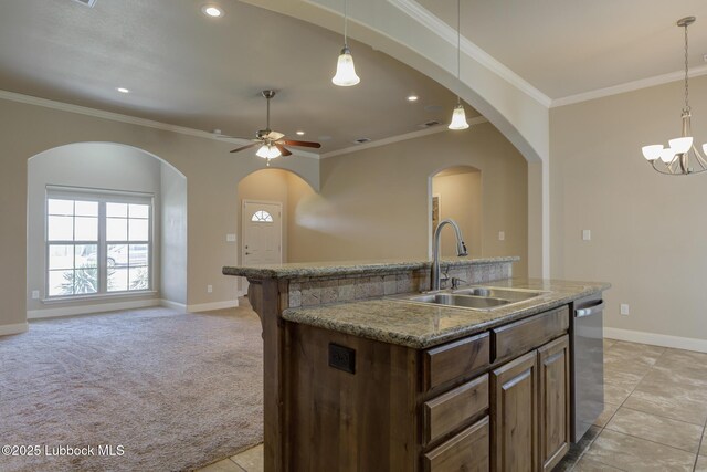 5207 Jarvis St, Lubbock, TX 79416 - kitchen with a sink, stainless steel dishwasher, open floor plan, baseboards, and crown molding