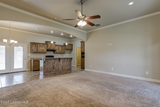 5207 Jarvis St, Lubbock, TX 79416 - kitchen with under cabinet range hood, baseboards, brown cabinets, ornamental molding, and light carpet