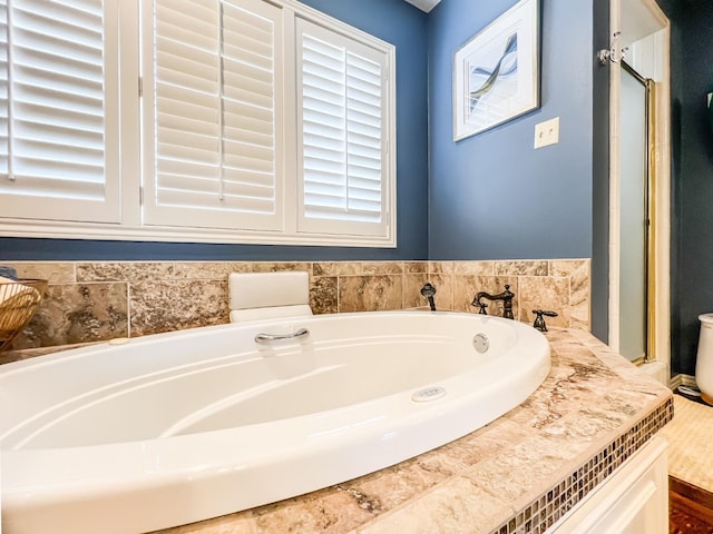 bathroom with tiled tub