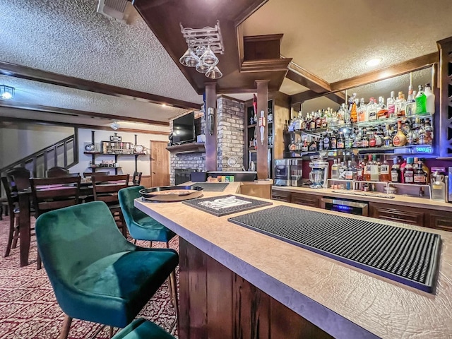 bar with beamed ceiling and a textured ceiling